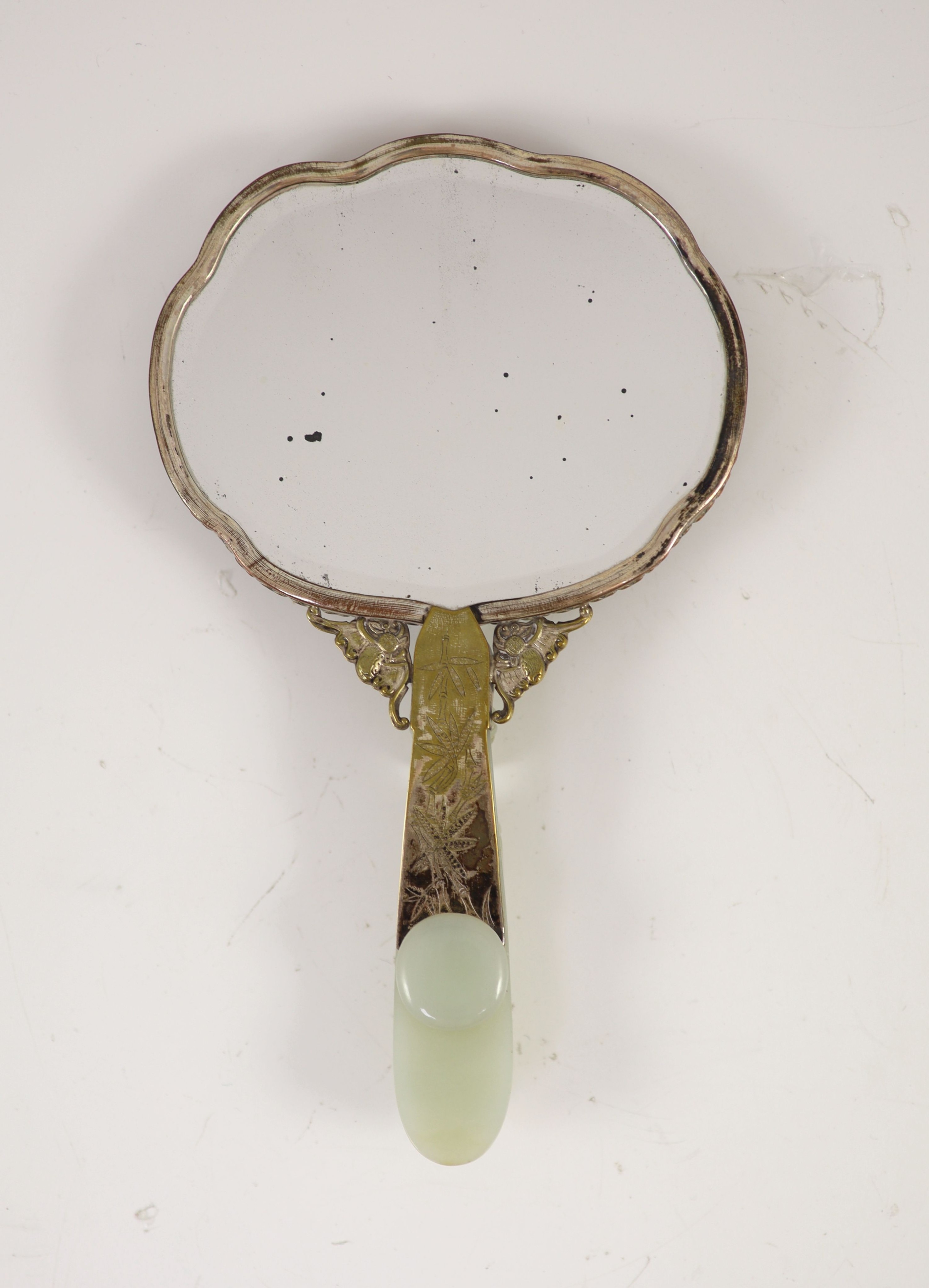 A Chinese pale celadon jade mounted hand mirror, the jade 18th/19th century, 24.2cm long, plaque 13.2 x 11.5cm, belt hook handle 12.3cm